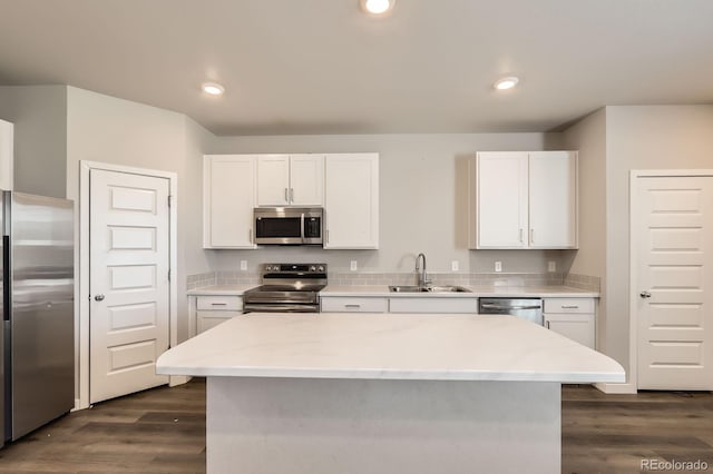 630 Apache Trl Unit D2, Ault, CO 80610 - kitchen with stainless steel appliances, dark wood-style floors, white cabinetry, a kitchen island, and recessed lighting