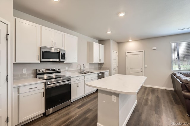 630 Apache Trl Unit D2, Ault, CO 80610 - kitchen with stainless steel appliances, dark wood-type flooring, white cabinets, and recessed lighting