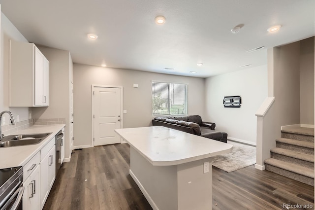 630 Apache Trl Unit D2, Ault, CO 80610 - kitchen with dark wood-type flooring, a center island, appliances with stainless steel finishes, white cabinets, and recessed lighting