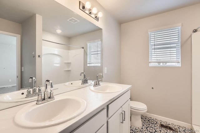 630 Apache Trl Unit D2, Ault, CO 80610 - bathroom with healthy amount of natural light, double vanity, a shower, and tile patterned flooring
