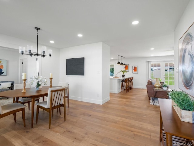 15229 Navajo St, Broomfield, CO 80023 - dining room with light wood-style floors, a chandelier, and recessed lighting