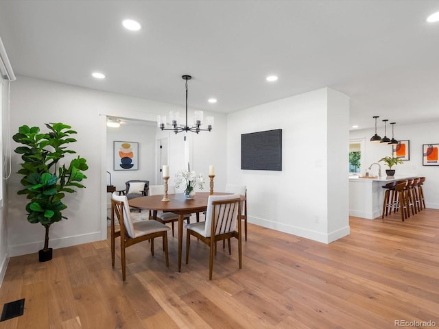 15229 Navajo St, Broomfield, CO 80023 - dining space with light wood finished floors, recessed lighting, and a chandelier
