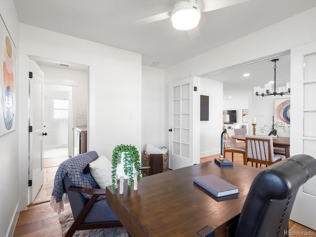 15229 Navajo St, Broomfield, CO 80023 - home office with a ceiling fan, light wood-type flooring, and a chandelier