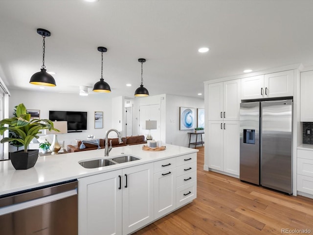 15229 Navajo St, Broomfield, CO 80023 - kitchen with appliances with stainless steel finishes, recessed lighting, decorative light fixtures, light countertops, and white cabinets