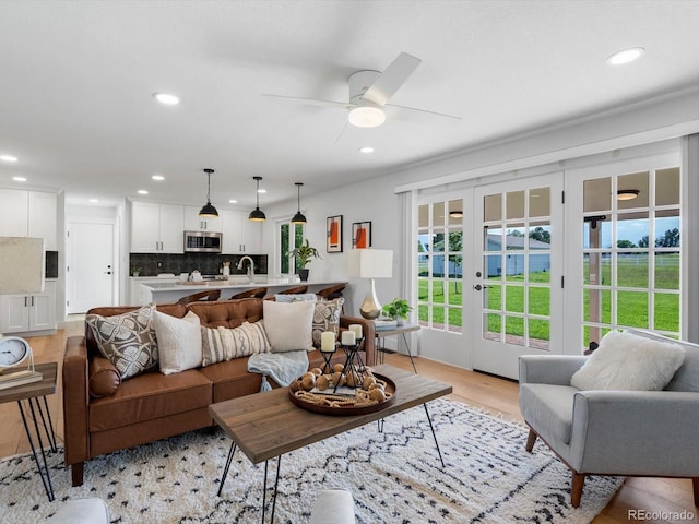 15229 Navajo St, Broomfield, CO 80023 - living room featuring light wood-style floors, recessed lighting, ceiling fan, and french doors