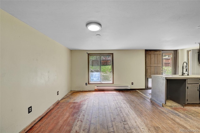 200 Rd P37, Bailey, CO 80421 - unfurnished living room featuring a baseboard radiator and wood-type flooring