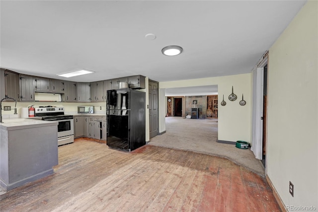 200 Rd P37, Bailey, CO 80421 - kitchen with freestanding refrigerator, range with electric cooktop, stainless steel microwave, light wood-type flooring, and light countertops