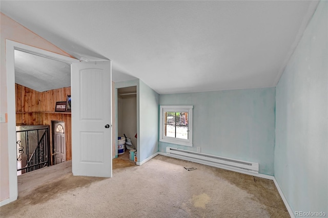 200 Rd P37, Bailey, CO 80421 - unfurnished bedroom featuring a baseboard radiator, carpet, lofted ceiling, wood walls, and a closet