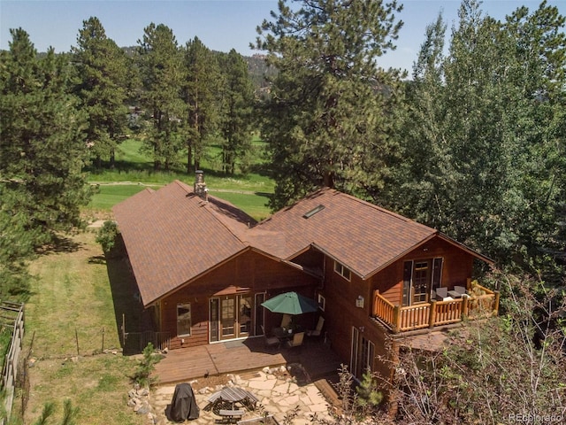 29090 Golf Way, Evergreen, CO 80439 - back of house with a wooden deck, french doors, a patio, a shingled roof, and a wooded view