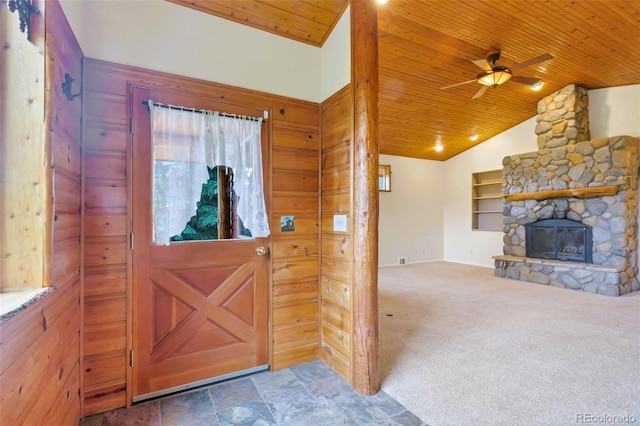 29090 Golf Way, Evergreen, CO 80439 - carpeted entryway with wood ceiling, a ceiling fan, a stone fireplace, lofted ceiling, and stone finish flooring