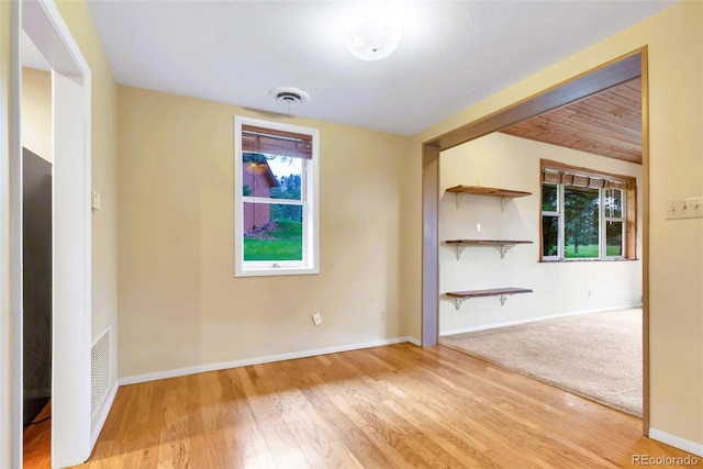 29090 Golf Way, Evergreen, CO 80439 - unfurnished living room featuring healthy amount of natural light and wood finished floors