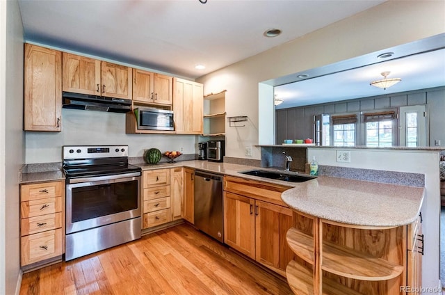 29090 Golf Way, Evergreen, CO 80439 - kitchen featuring stainless steel appliances, under cabinet range hood, open shelves, a peninsula, and light wood-style floors