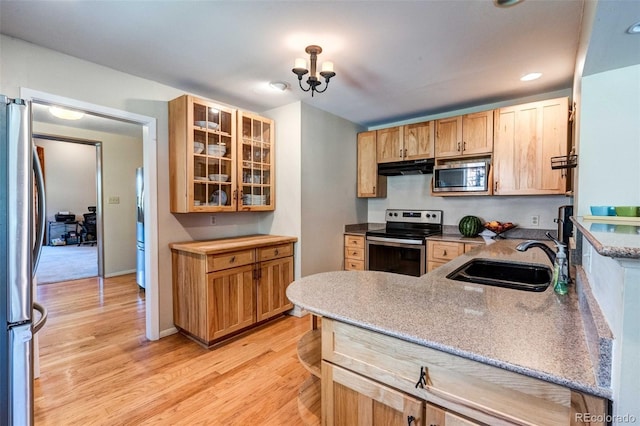 29090 Golf Way, Evergreen, CO 80439 - kitchen with stainless steel appliances, under cabinet range hood, light wood-type flooring, glass insert cabinets, and recessed lighting