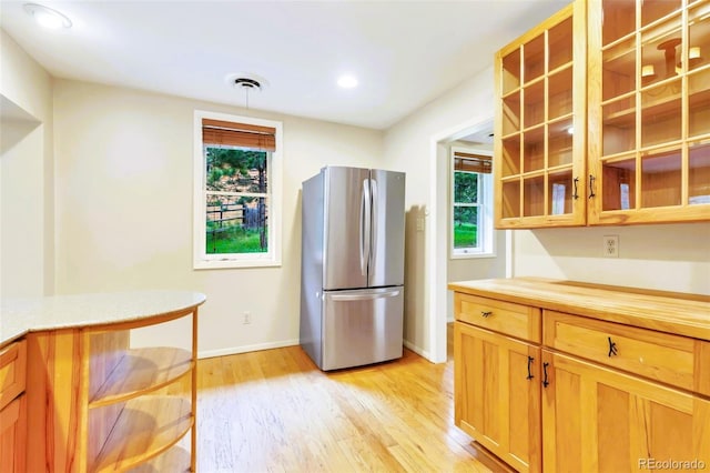 29090 Golf Way, Evergreen, CO 80439 - kitchen with freestanding refrigerator, light wood-style flooring, glass insert cabinets, recessed lighting, and wood counters