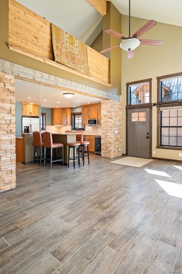 127 Silver Sage Rd, Granby, CO 80446 - entrance foyer featuring wood finished floors, beverage cooler, high vaulted ceiling, and ceiling fan