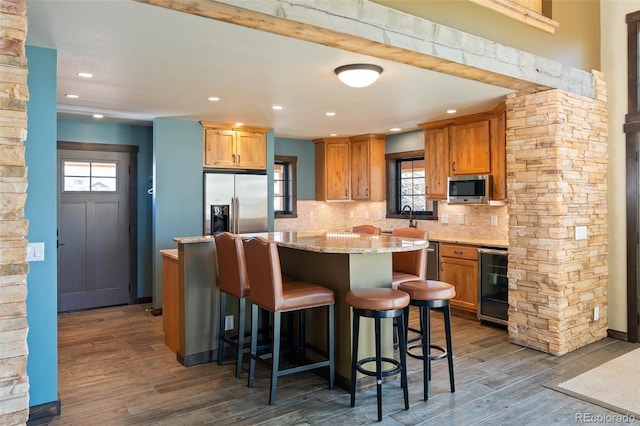 127 Silver Sage Rd, Granby, CO 80446 - kitchen with a center island, beverage cooler, stainless steel appliances, backsplash, and dark wood-style flooring