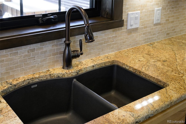 127 Silver Sage Rd, Granby, CO 80446 - interior details with decorative backsplash, light stone countertops, and a sink
