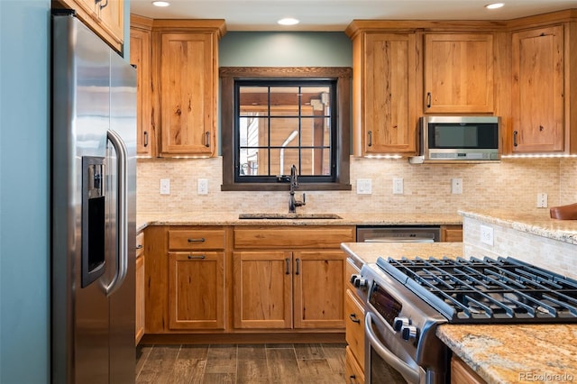127 Silver Sage Rd, Granby, CO 80446 - kitchen with a sink, tasteful backsplash, dark wood-style flooring, light stone countertops, and appliances with stainless steel finishes
