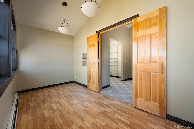 127 Silver Sage Rd, Granby, CO 80446 - unfurnished room featuring a baseboard heating unit, light wood-style floors, vaulted ceiling, and baseboards