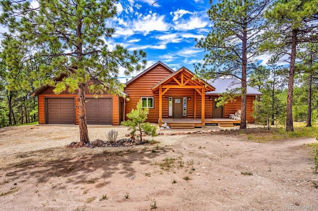 4513 County Road 323, Westcliffe, CO 81252 - view of front of house with driveway, a garage, and a porch