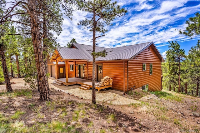 4513 County Road 323, Westcliffe, CO 81252 - back of house with a metal roof, a wooden deck, and log veneer siding