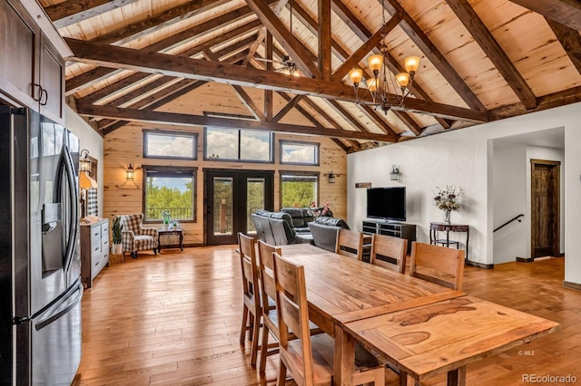 4513 County Road 323, Westcliffe, CO 81252 - dining space featuring light wood-style floors, a wooden ceiling with exposed beams, high vaulted ceiling, a chandelier, and french doors