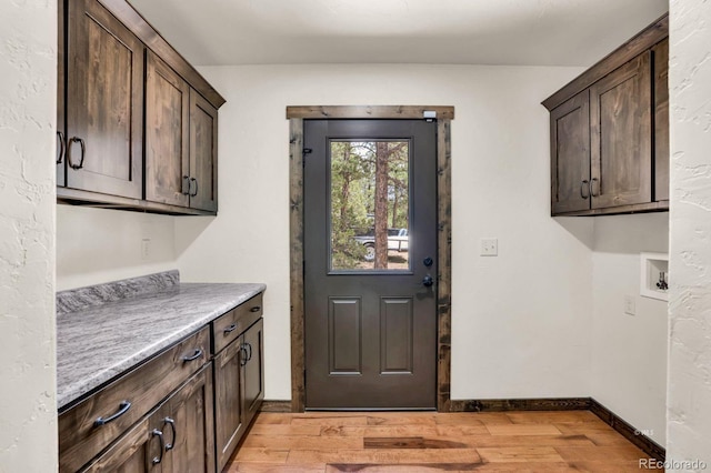 4513 County Road 323, Westcliffe, CO 81252 - washroom with cabinet space, light wood-style flooring, and hookup for a washing machine