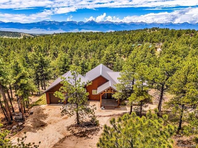 4513 County Road 323, Westcliffe, CO 81252 - aerial view of property and surrounding area with a forest and a mountainous background