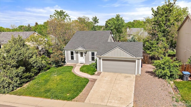 904 Clover Cir, Lafayette, CO 80026 - view of front of house featuring board and batten siding, an attached garage, concrete driveway, and a shingled roof