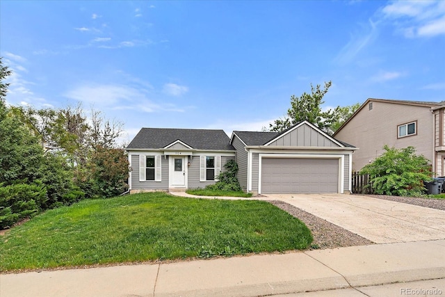 904 Clover Cir, Lafayette, CO 80026 - view of front of home featuring board and batten siding, a garage, concrete driveway, and a front yard