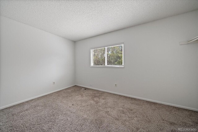 904 Clover Cir, Lafayette, CO 80026 - unfurnished room featuring carpet flooring, a textured ceiling, and baseboards