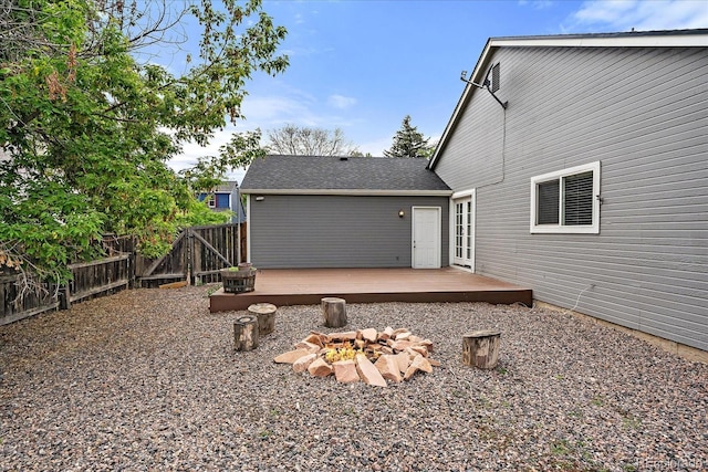904 Clover Cir, Lafayette, CO 80026 - back of house with a fire pit, a fenced backyard, a wooden deck, roof with shingles, and french doors