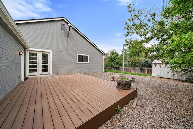 904 Clover Cir, Lafayette, CO 80026 - deck with fence, a storage shed, an outbuilding, and french doors