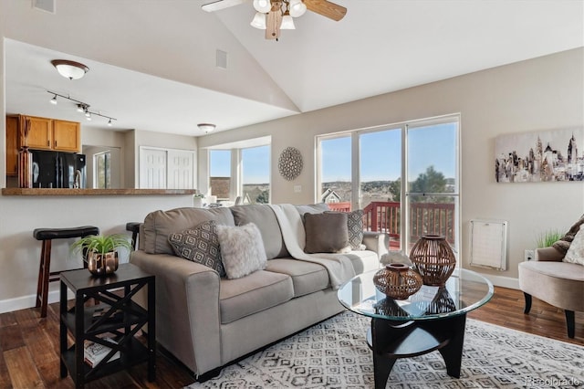 living room with ceiling fan, lofted ceiling, and hardwood / wood-style flooring