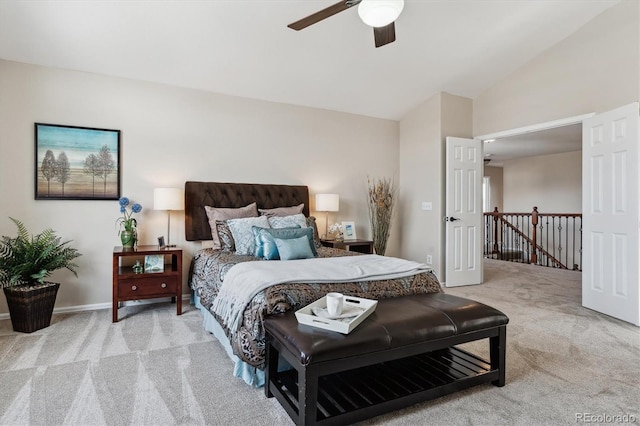 bedroom featuring ceiling fan, light carpet, and vaulted ceiling