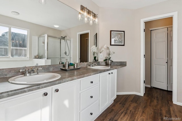 bathroom featuring an enclosed shower, vanity, and hardwood / wood-style floors