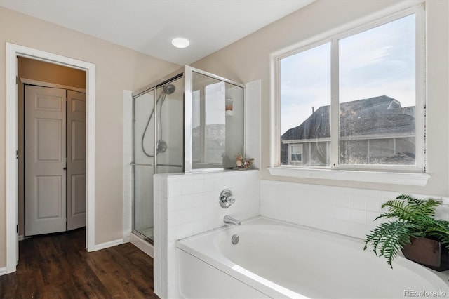 bathroom featuring separate shower and tub and wood-type flooring