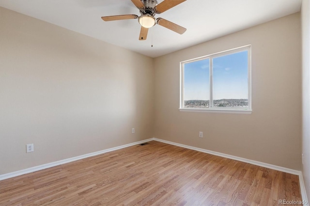 empty room featuring ceiling fan and light hardwood / wood-style floors