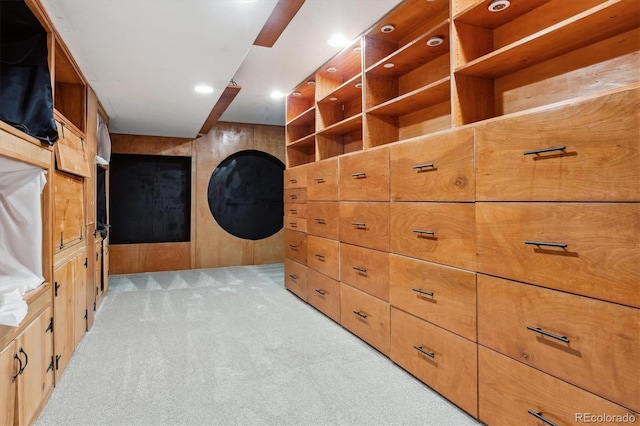 walk in closet featuring light colored carpet