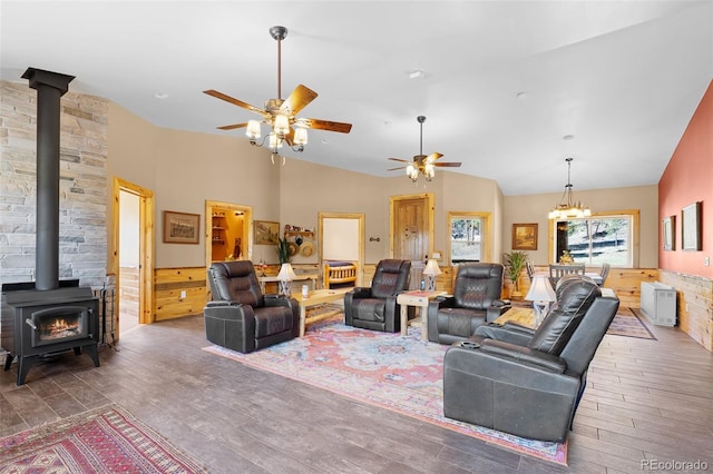14552 Timber Valley Dr, Weston, CO 81091 - living room with a wood stove, ceiling fan, hardwood / wood-style floors, vaulted ceiling, and a chandelier