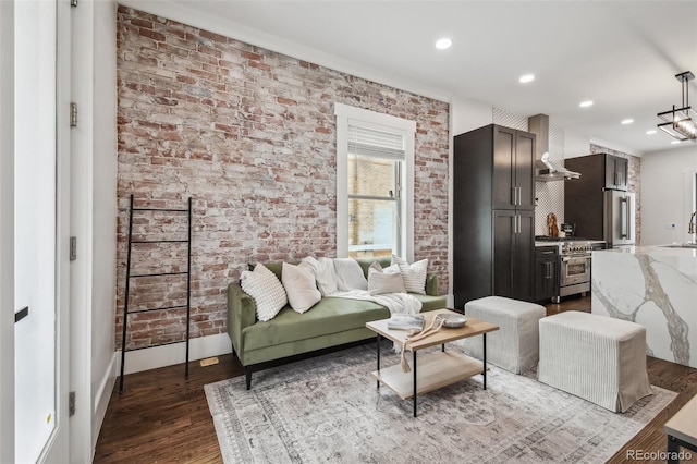 1024 W 8th Ave, Denver, CO 80204 - living area with brick wall, dark wood finished floors, baseboards, and recessed lighting