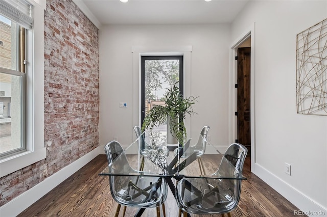 1024 W 8th Ave, Denver, CO 80204 - dining room featuring dark wood-style flooring, baseboards, and brick wall
