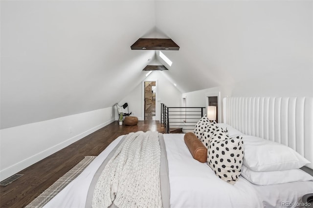 1024 W 8th Ave, Denver, CO 80204 - bedroom with wood finished floors, vaulted ceiling, and baseboards