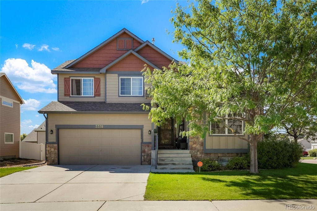 craftsman house with a front yard and a garage