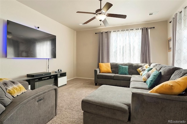 living room with light carpet and ceiling fan