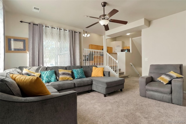 carpeted living room featuring ceiling fan