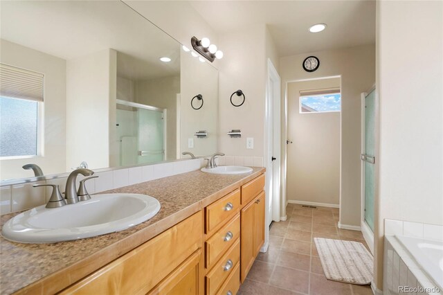 bathroom with tile patterned flooring, vanity, and separate shower and tub