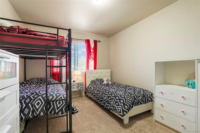 bedroom with light carpet and multiple windows