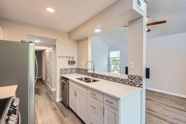 3539 S Fairplay Way Unit 10, Aurora, CO 80014 - kitchen featuring stainless steel appliances, a sink, light countertops, light wood-style floors, and ceiling fan