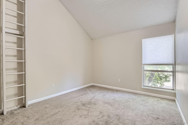 3539 S Fairplay Way Unit 10, Aurora, CO 80014 - carpeted empty room featuring a textured ceiling, vaulted ceiling, and baseboards